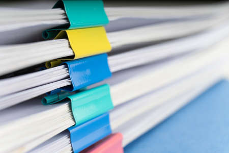 Mock up, stack of papers documents in archives files with paper clips on desk at offices, business concept.の写真素材