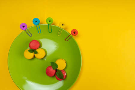 Colorful macaroons on a green plate. Concept for the holidayの写真素材