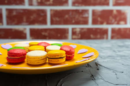 Sweet macaroons on stone background with copy space.