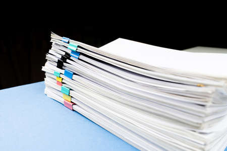 Mock up, stack of papers documents in archives files with paper clips on desk at offices, business concept.の写真素材