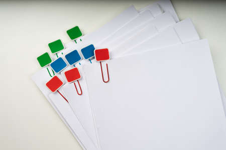 Mock up, stack of papers documents in archives files with paper clips on desk at offices, business...