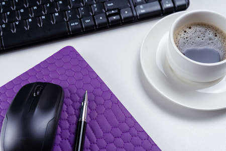 Office table desk. Workspace with note book, keyboard, office supplies and coffee cup on white background.の写真素材