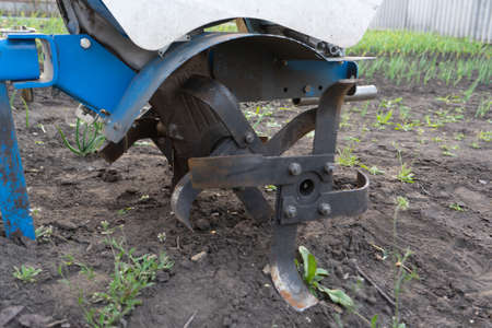 Plow the land with a motorcycle cultivator. Plow the land. Work the landの写真素材