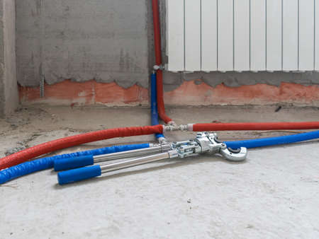 Plumbing copper pipe crimper press tube tool. Heating pipes connected by press fittings. Hydraulic,...