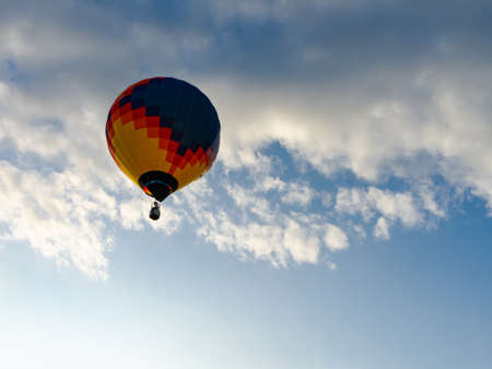 Colorful hot air balloons flying in blue sky. Few colorful, hot air balloons descending at the Balloon Festivalの写真素材