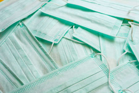 Medical masks are laid out on a yellow background.の写真素材