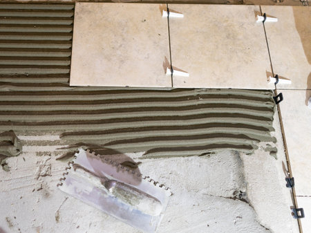 Tile levelling system with plastic clips and wedges. Close-up view, selective focus, blurred background.の写真素材