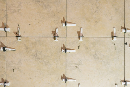 Tile levelling system with plastic clips and wedges. Close-up view, selective focus, blurred background.の写真素材