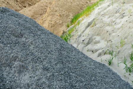 Piles of rubble and sand are stacked on the construction siteの写真素材