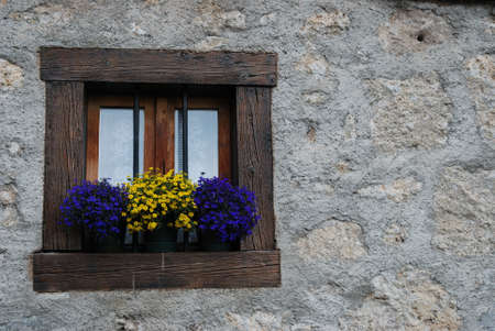 Little wooden window with flowers