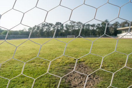 close up soccer goal net with sunshine in the morningの写真素材