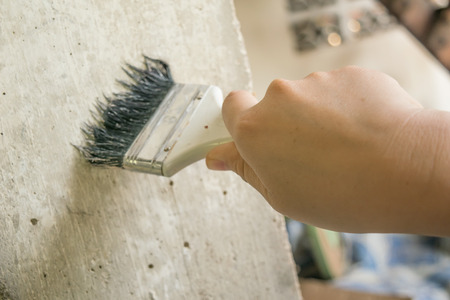 woman hand decorating or painting with a paint brushの写真素材