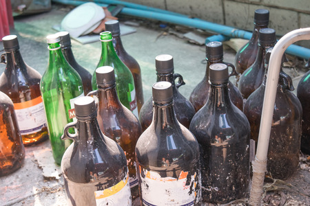 Old dirty bottles on the floorの写真素材