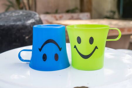 two plastic glass with smile iconの写真素材
