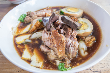 Chinese roll noodle soup or Kuey Jap (paste of rice flour) on wooden tableの写真素材