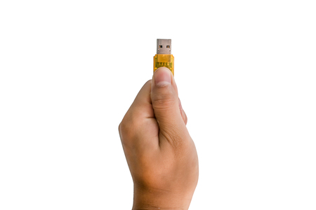Hand holding flash drive isolated on white background with clipping pathの写真素材