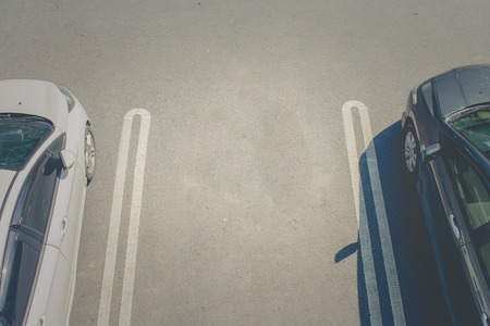 Top view empty space of car parking lot between other cars at public park.の写真素材