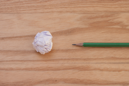 Business Creative and Idea Concept : Used pencil with white crumpled paper ball put on wooden foor. (Selective focus)の写真素材
