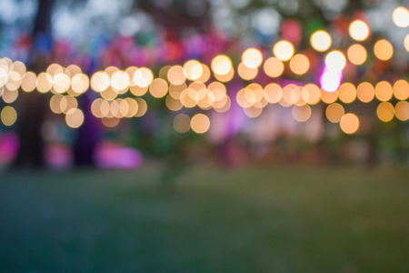 Abstract blurred image of colorful day festival with bokeh from light at outdoor garden in evening.