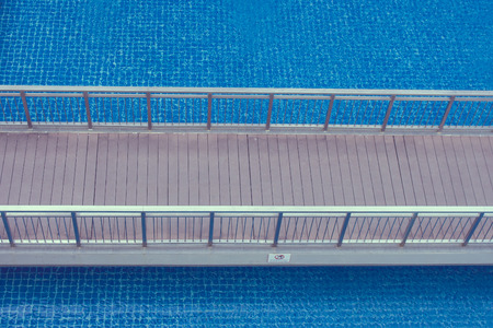 Top view of wooden walkway or footbridge over swimming pool at the resort.の写真素材