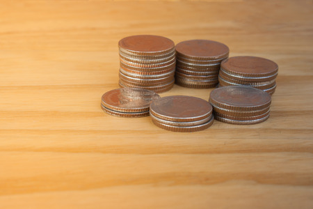 Business and Financial Concept : Stack of silver coins (Baht) put on wooden table. (Selective focus)の写真素材
