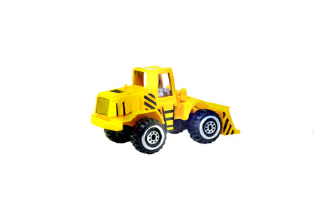 Close up yellow construction truck toys isolated on white background.