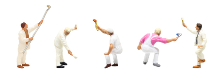 Miniature figurine character as painter standing and working in posture isolated on white background.の写真素材