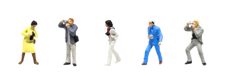 Miniature figurine character as photographer standing and working in posture isolated on white...