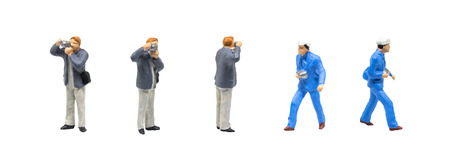 Miniature figurine character as photographer standing and working in posture isolated on white background.の写真素材