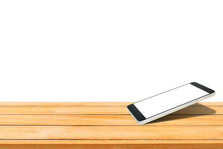 Close up smartphone with blank white screen put on wooden table isolated on white background.の写真素材