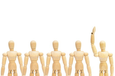 Business Leadership Concept : One in group of wooden figure mannequin rise hand up on white background.の写真素材