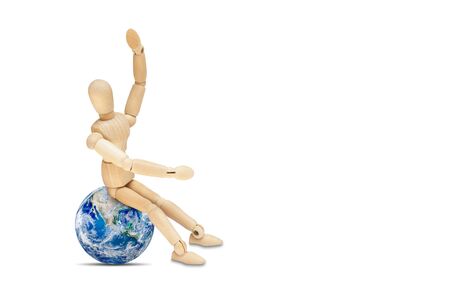 Business Globalization Concept : Wooden figure mannequin sitting on planet earth globe isolated on white background.の写真素材