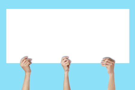 Business Marketing and Advertising Concept : Many hands holding empty space white paper and showing over head.の写真素材