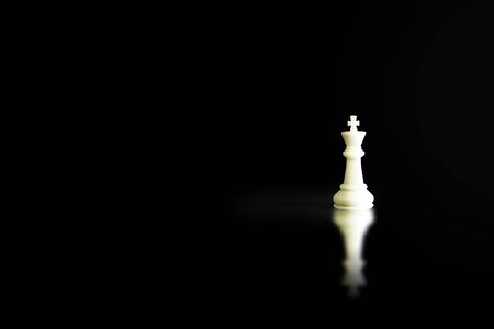 Business Leadership Concept : White King chess piece standing on floor with shadow shading on floor.の写真素材