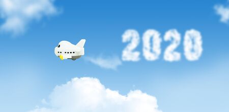 New Years Concept : White small airplane toys flying in the sky and squirt white smoke is words 2020...