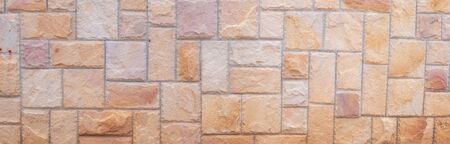 Abstract panorama image of Orange grunge stone wall texture background for exterior decoration.