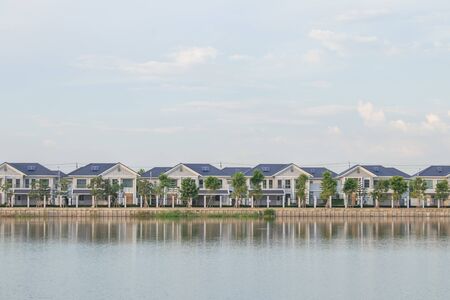 Real state concept : New home or residential building under construction locate nearly lake with blue sky and sunlight in the evening time.の写真素材