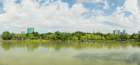Beautiful panorama view of City public park with lake and green trees in background.の写真素材