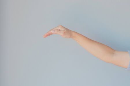 Caucasian female hand gesture or Hand in gesturing with gray background.の写真素材