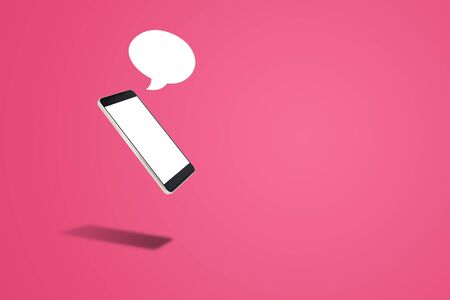 Business Communication Concept : Black Smartphone with blank white screen and speech bubble on pink background.の写真素材