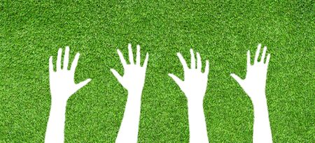 Ecology and Environment Concept : Female hands gesturing shape on green artificial grass.