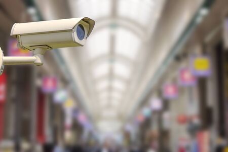 Used Closed Circuit Television Camera or Security CCTV camera with blurry image of walking street in...