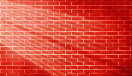 Red brown vintage grunge brick wall texture background with light shading on wall.の写真素材