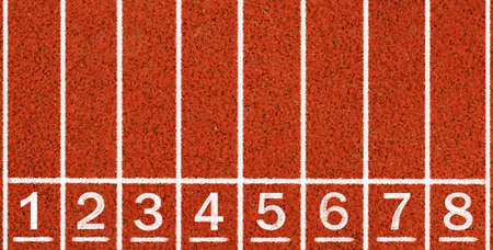 Running track with white lines and numbers from top view.