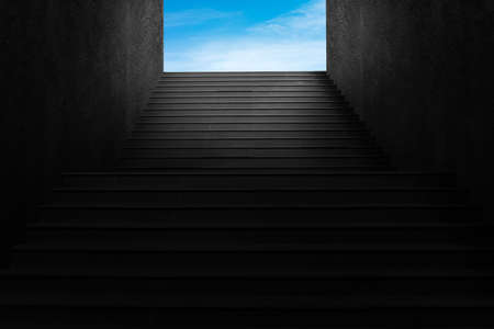Abstract low key image of Front view architecture of concrete staircase leading to blue sky.の写真素材