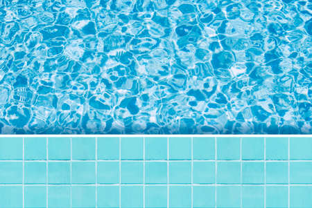Blue tiles mosaic floor beside swimming pool from top view.