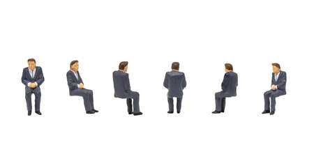 Miniature people as seated passenger isolated on white background.の写真素材
