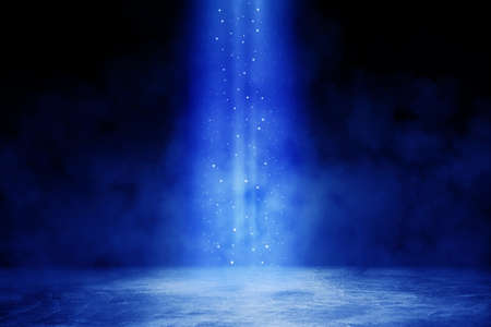 Empty space of Studio dark room with blue lighting effect and fog or mist on concrete floor in black background.の写真素材