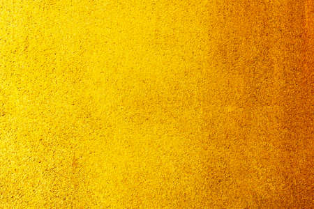 Abstract image of Empty space concrete wall grunge texture background with golden gradient lighting...