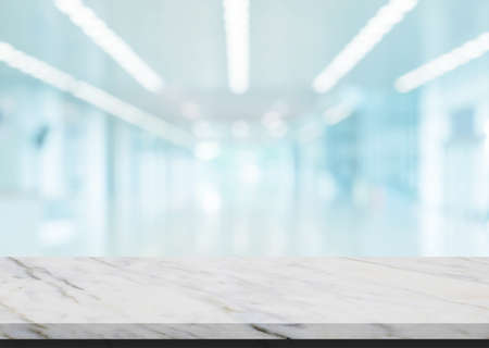 Abstract image of Marble stone table top grunge texture background with blurry image inside of shopping mall for product showing.の写真素材